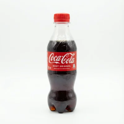 Bouteille en plastique COCA COLA 30CL vue de face, avec son étiquette et son bouchon rouges, sur un fond blanc uni.