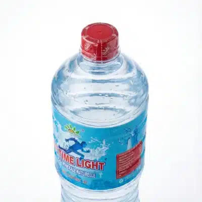 Vue de dessus de la bouteille en plastique d'EAU MINERALE ULTIMATE 1.5L avec son étiquette bleue et son bouchon rouge vif.