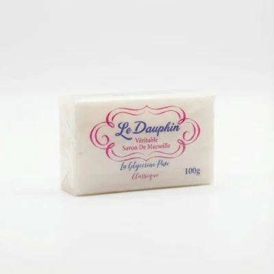 Vue de face du SAVON LE DAUPHIN CLASSIQUE 100G, un pain blanc sous film plastique avec un lettrage rose et bleu.