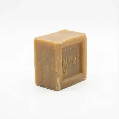 Vue de latérale du Savon Mayor 360g, un bloc cubique de couleur brun-beige posé sur un fond blanc.